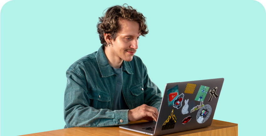 young person at his pc on a green background