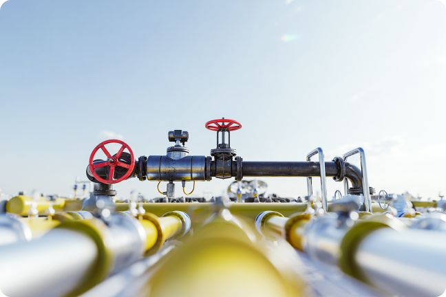 Industrial gas pipelines with red control valves.