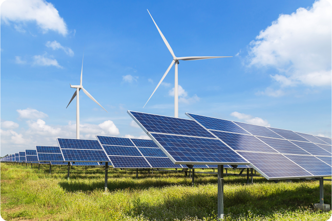 Solar panels and wind turbines in a sunny field.